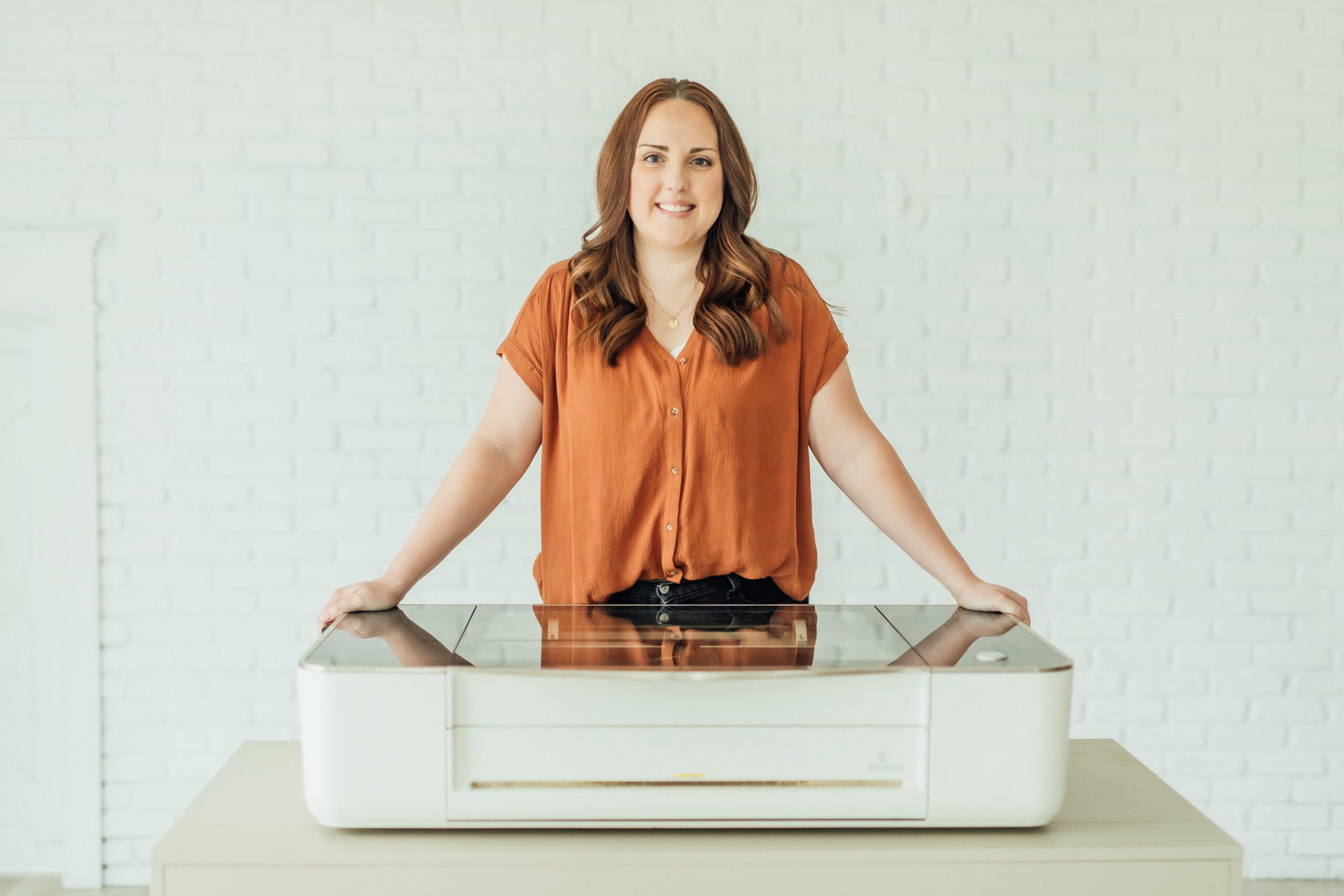 Ashlee Wiggins standing behind her laser and smiling