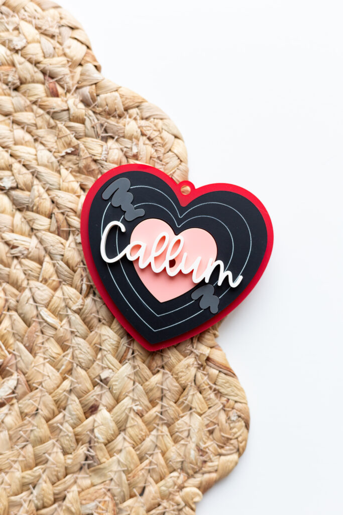 Laser cut heart shape tag for Valentine's Day that mimics a vinyl record and is made of acrylic by Made of Embers